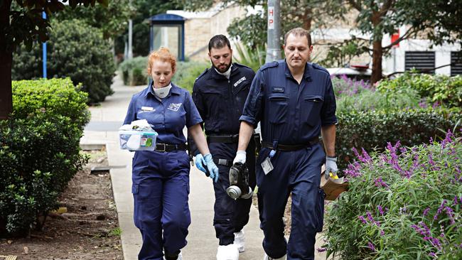 Forensic police entering the apartment block where a three-year-old boy was found deceased and a man critical injured in Riverwood. Picture: Adam Yip