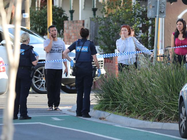 Police hold back locals at the scene of a shooting in Richmond. Picture: Alex Coppel