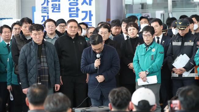 A Jeju Air official bows his head and apologises to the bereaved families of passengers. Picture: Yonhap/AFP