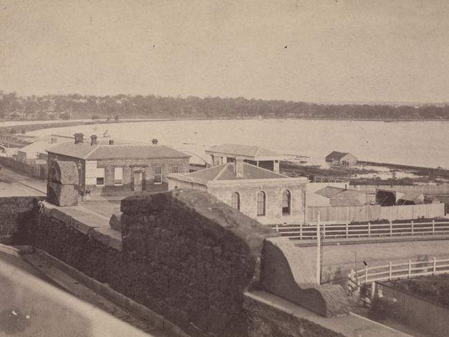 The first morgue (centre) and coroners offices taken from the top of Princes Bridge Hotel, with a flooded Yarra River in background. Picture: State Library of Victoria.