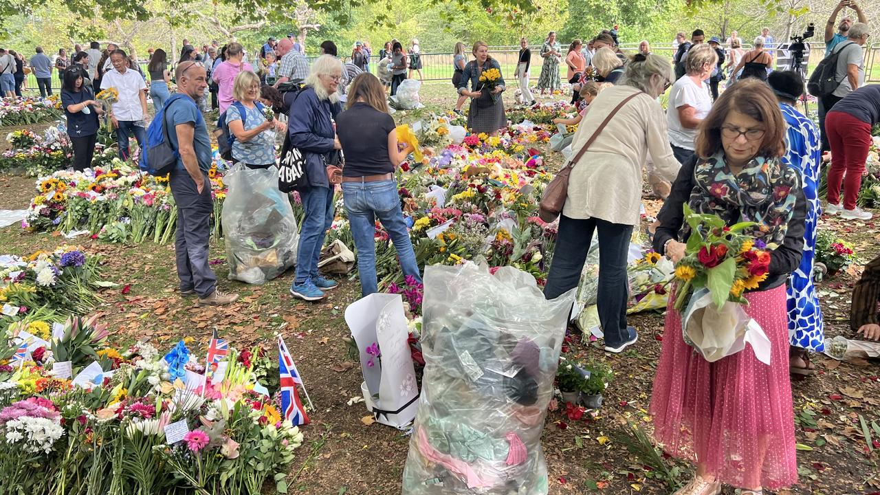 A group of visitors took it upon themselves to remove plastic from any floral arrangements on Monday. Picture: Chantelle Francis