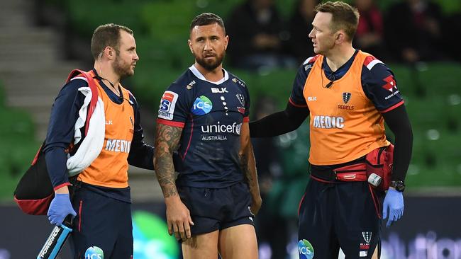 Trainers attend to Quade Cooper after he was concussed on Friday night. Picture: AAP