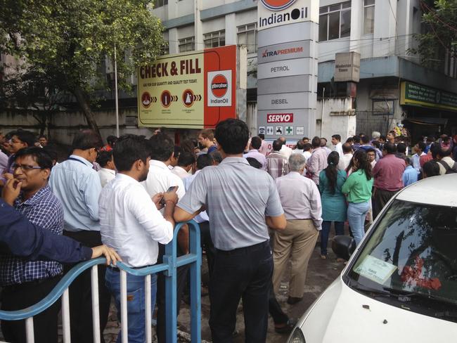 People stand outdoors after tremors shook buildings in Kolkata, India. Picture: AP Photo/Bikas Das