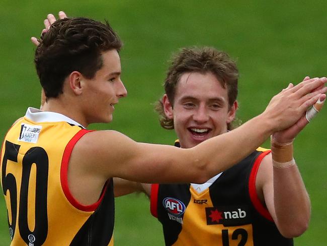 MELBOURNE, AUSTRALIA - MAY 11: Makaio Haywood of the Stingrays (R) and Lachlan Williams of the Stingrays celebrate during the round seven NAB League match between the Western Jets and Dandenong at Downer Oval on May 11, 2019 in Melbourne, Australia. (Photo by Kelly Defina/AFL Photos/Getty Images)