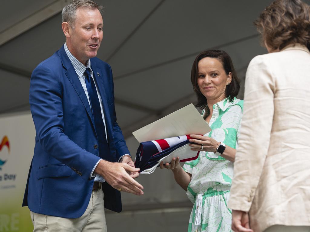 Groom MP Garth Hamilton presents Emily MacManus (centre) and Dr Tarn McLean of The Lighthouse Toowoomba with an Australian parliamentary flag at Toowoomba Australia Day celebrations at Picnic Point, Sunday, January 26, 2025. Picture: Kevin Farmer