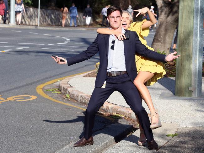 People leaving the Melbourne Cup Day at Eagle Farm. Picture: AAP/Richard Gosling