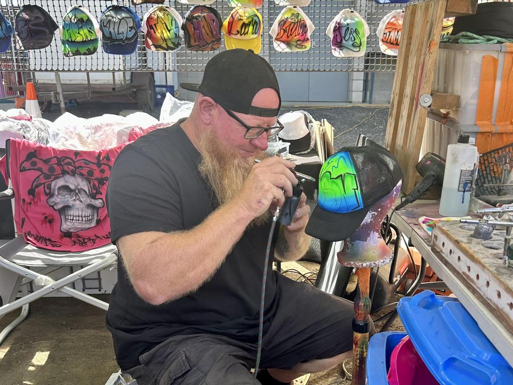 Steve Lowe spray paints a hat