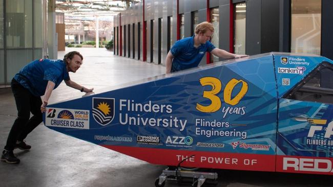 Ethan (left) and Bryn (right) pushing the car designed and built by the Flinders University team. Picture: Supplied