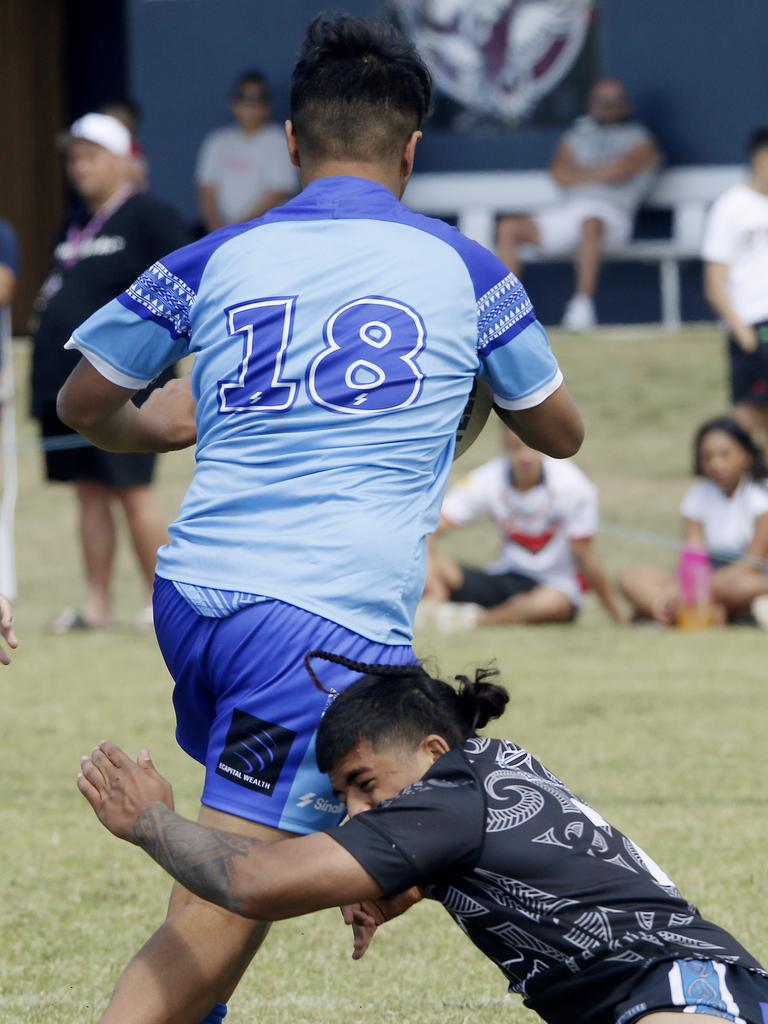 Kingston Taliu from Samoa white tackled by Amari-Jay Tangi Maori Pango. Under 16 Boys Maori Pango v Samoa white. Harmony Nines Rugby League. Picture: John Appleyard