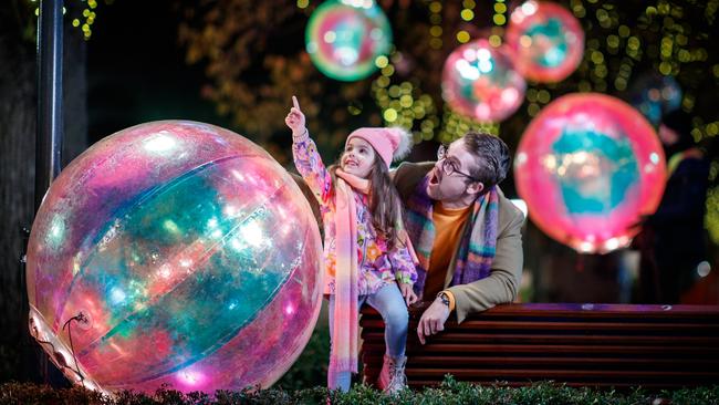 Four-year-old Ivy and her father AJ White check out the Ephemeral Droplets installation on North Terrace, part of the City Lights display which runs from July 7 to 23 at the Illuminate Adelaide festival. Picture: Matt Turner.