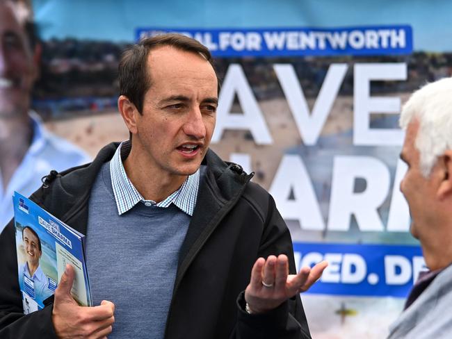 Former Liberal member for Wentworth Dave Sharma speaks to a voter at a polling station at Bondi Beach on election day. (Photo by STEVEN SAPHORE / AFP)