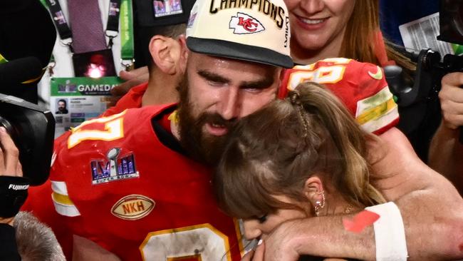 (FILES) US singer-songwriter Taylor Swift and Kansas City Chiefs' tight end #87 Travis Kelce embrace after the Chiefs won Super Bowl LVIII against the San Francisco 49ers at Allegiant Stadium in Las Vegas, Nevada, February 11, 2024. Kelce is helping survivors of the shooting that marred the Kansas City Chiefs' Super Bowl victory parade, after his world-famous girlfriend Swift did the same, NBC news reported on February 17, 2024. The shooting on February 14 left one woman dead and 22 people injured â including two girls in the Reyes family. Kelce's Eighty-Seven Running foundation made two $50,000 donations to a GoFundMe raising money to support the Reyes family, a Kelce representative confirmed to NBC. (Photo by Patrick T. Fallon / AFP)