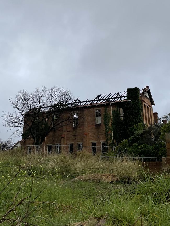 The roof of the main building remains extremely damaged by fires. Picture: Niki Iliagoueva