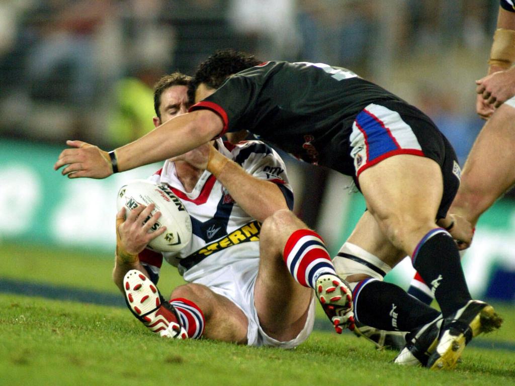 Brad Fittler (ball) and Richard Villasanti clash heads in the 2002 grand final. Picture: Greg Porteous