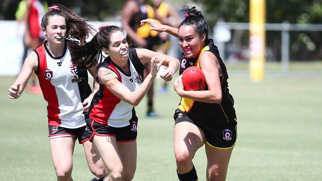 Tigers' Tarin Moke shakes off the Saints defenders to get a kick away in the AFL Cairns Women's match between the North Cairns Tigers and the Cairns Saints, held at Watson's Oval, Manunda. PICTURE: BRENDAN RADKE.