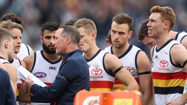 Adelaide coach Don Pyke talks with his players during the loss to the Crows at the MCG. Picture: AAP Image/David Crosling