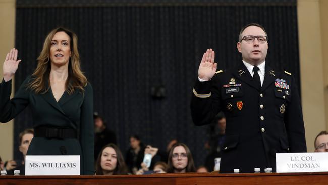 Jennifer Williams, an aide to Vice President Mike Pence, left, and National Security Council aide Lt. Col. Alexander Vindman, are sworn in to testify before the House Intelligence Committee. Picture: AP