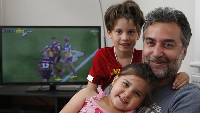 Basak Yagci watching the NRL in his London home with son Kaya and daughter Lara. Picture: Hollie Adams