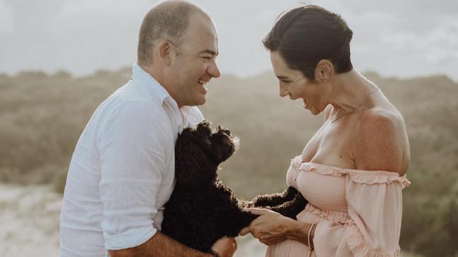 Duncan and Becky Drummond with their cavoodle Hunk during a pregnancy photoshoot at Fingal Head. Picture: Alix Duyn.