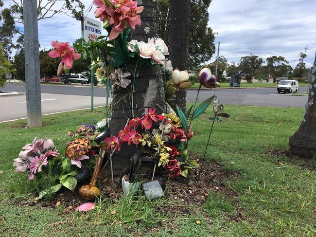 A makeshift memorial at the scene of the incident at a Nambucca shopping centre car park.