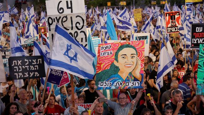 An image depicting Noa Argamani, one of four Israeli hostages rescued by the Israeli army, is held up as Israeli activists rally during an anti-government demonstration, calling for the return of Israeli hostages being held in the Gaza Strip. Picture: AFP