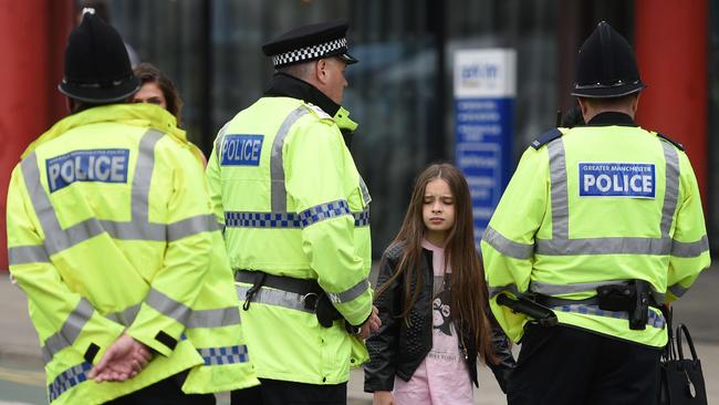 Police talk to people affected by the deadly terror attack at the Ariana Grande concert at Manchester Arena. (Pic: AFP/Oli SCARFF)