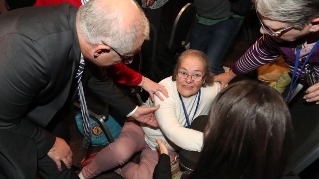 Scott Morrison helps a woman at the CWA event named Margaret after she was knocked over after the egging attempt. Picture: Alex Coppel. 