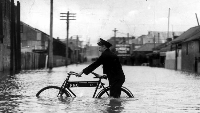 In December 1934, being a postie was a tough gig as flooding turned the streets of Melbourne into canals