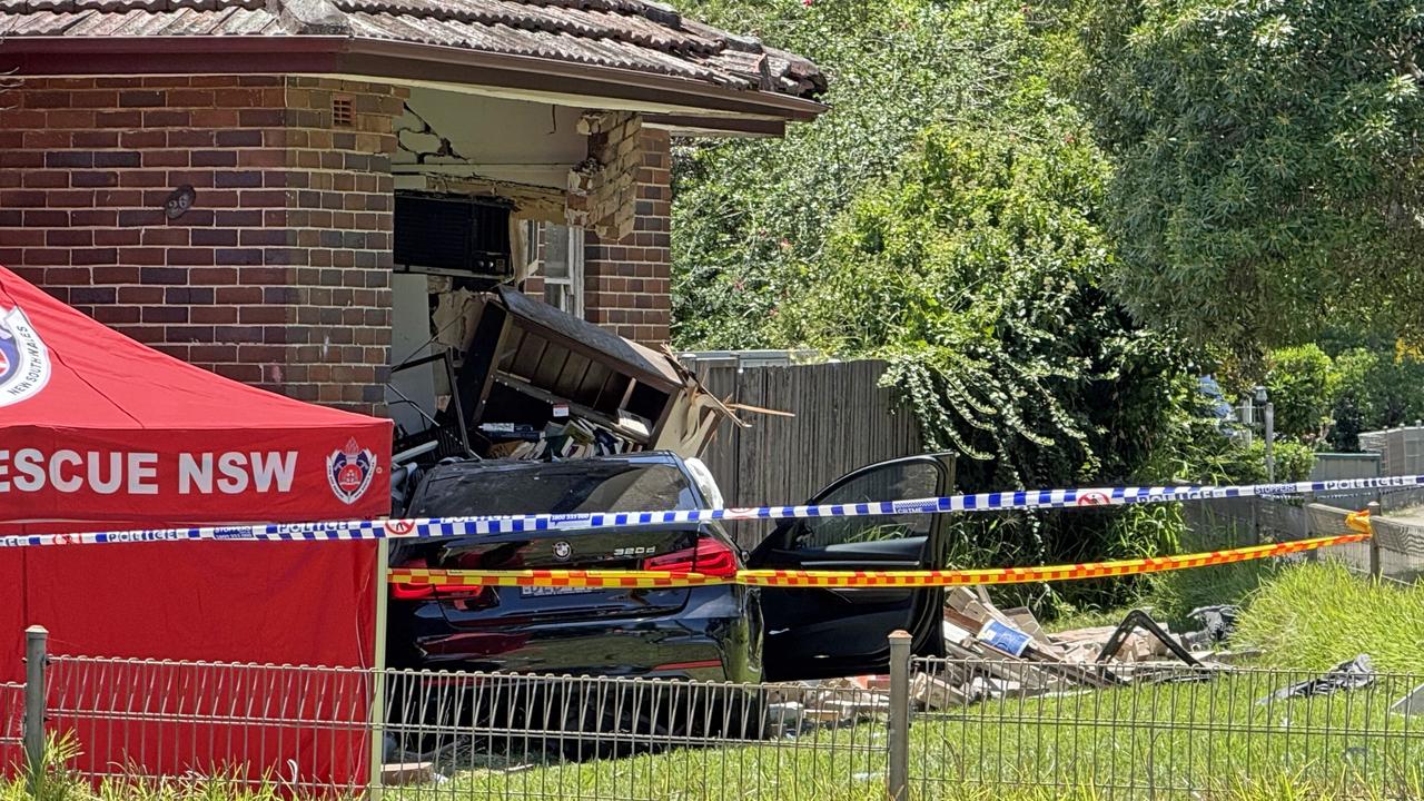 Woman dead after car ploughs into home