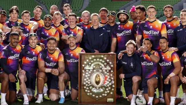 MELBOURNE, AUSTRALIA - SEPTEMBER 04: Melbourne Storm coach Craig Bellamy and Storm players pose for a photo with the JJ Giltinan Shield before a Melbourne Storm NRL media opportunity on September 04, 2024 in Melbourne, Australia. (Photo by Darrian Traynor/Getty Images)