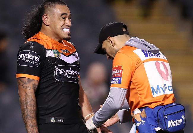 Mahe Fonua of the Tigers receives attention from a trainer.