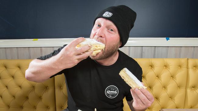 Jason Peters tries the famous vanilla slices at The Vanilla Slice cafe Sorrento. Picture Norm Oorloff