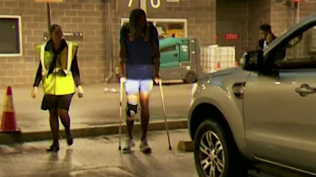 Nic Naitanui arrives back in Perth on crutches. West Coast Eagles official Peter Staples then turned on a cameraman who was filming from a distance.