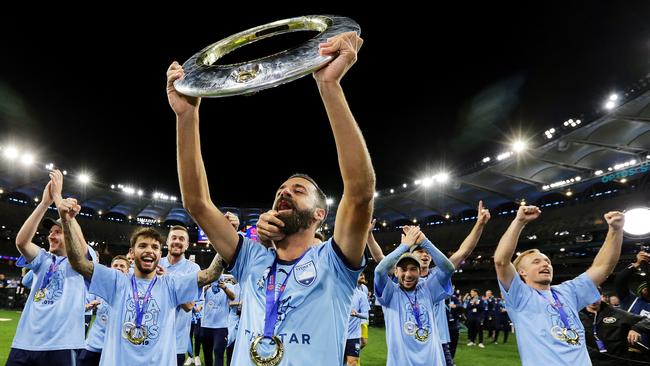 Sydney FC’s Alex Brosque celebrates with the A-League trophy after victory against Perth Glory in the grand final last Sunday. Picture: Getty Images