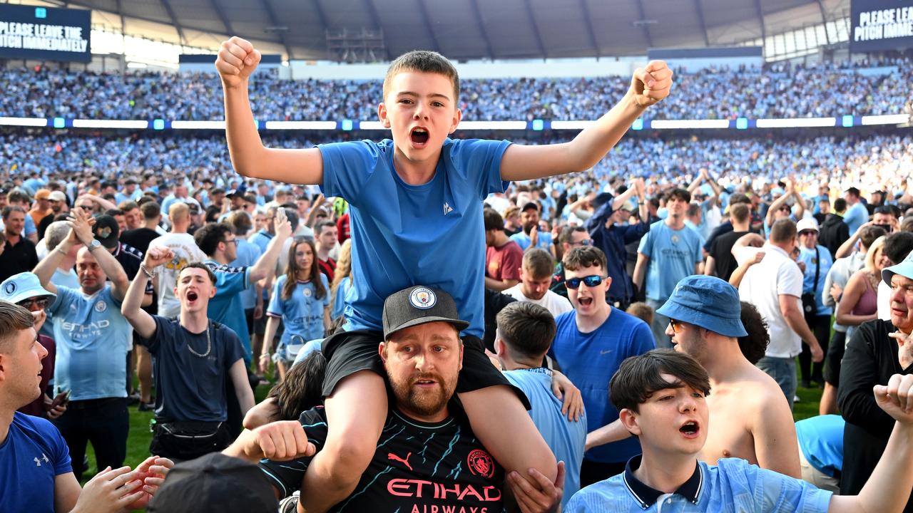 Manchester City fans poured onto the pitch after the game.