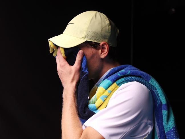 MELBOURNE, JANUARY 20, 2025: 2025 Australian Open Tennis, day nine. Jannik Sinner (ITA) feels the heat against Holger Rune (DEN) during their fourth round singles match on Rod Laver Arena. Picture: Mark Stewart