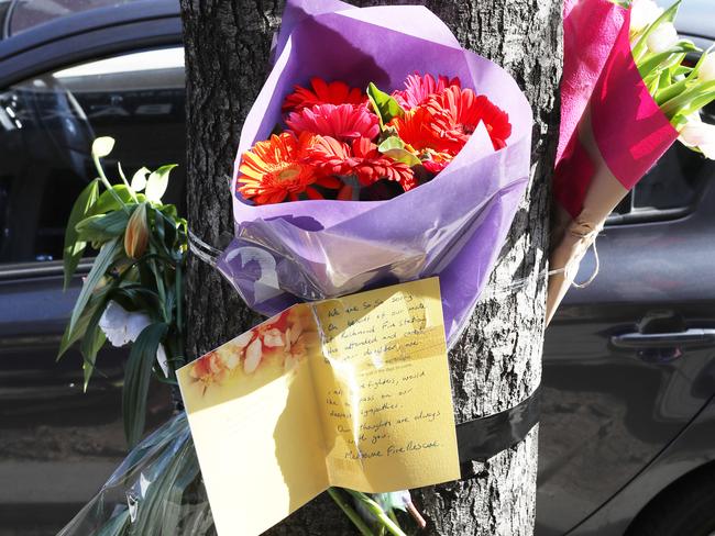 A flower memorial at the site where a cyclist was killed on Chapel St. Picture: David Crosling