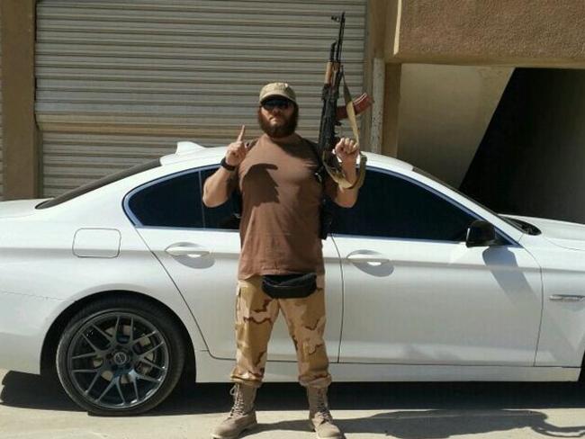 Australian terrorist Khaled Sharrouf posing with an AK-47 in front of a sports car from an undisclosed location within Iraq. Photo: Twitter