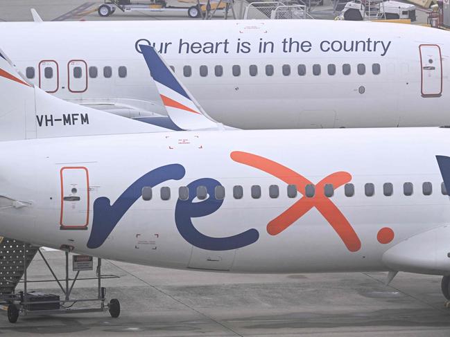 Rex Airlines Boeing 737 planes lay idle on the tarmac at Melbourne's Tullamarine Airport on July 31, 2024. The Australian regional airline Rex cancelled flights as it entered voluntary administration on July 31, leaving the fate of the country's third-largest carrier in serious doubt. (Photo by William WEST / AFP)