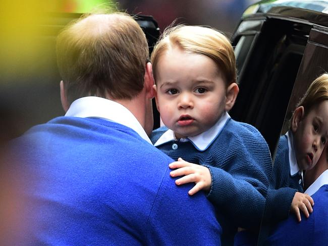 Britain's Prince William, Duke of Cambridge (L), helps his son Prince George of Cambridge out of a car as they return to the Lindo Wing at St Mary's Hospital in central London, on May 2, 2015 where his wife Catherine, Duchess of Cambridge, gave birth to their second child, a baby girl, earlier in the day. The Duchess of Cambridge was safely delivered of a daughter weighing 8lbs 3oz, Kensington Palace announced. The newly-born Princess of Cambridge is fourth in line to the British throne. AFP PHOTO / JUSTIN TALLIS