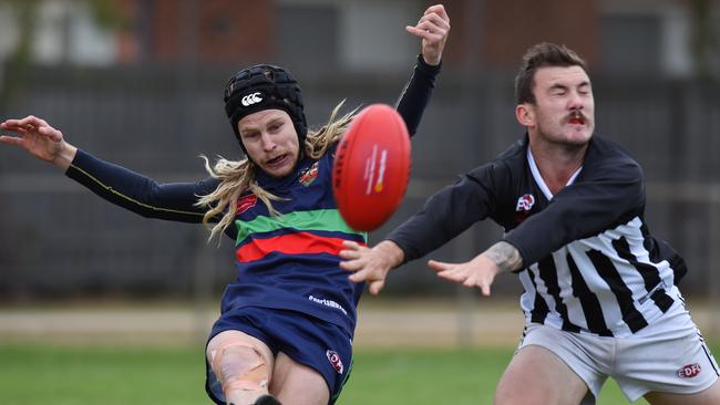 Matthew Gray gets a kick away under pressure from Dillon Rogan. Picture: Josie Hayden