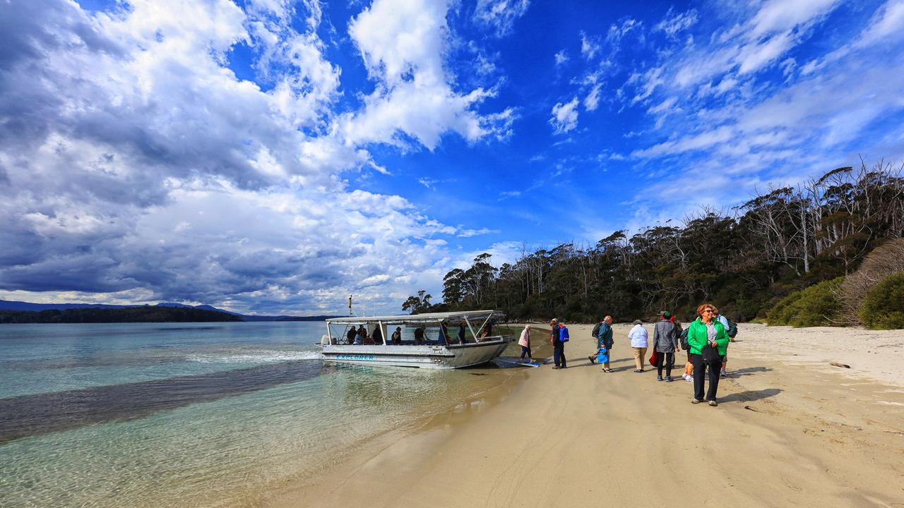 STUNNING SCENE: Visitors make their way up the beach at Cockle Creek, Tasmania.