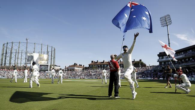 Nathan Lyon reaches for the Australian flag at the start of day three. Picture: Getty Images