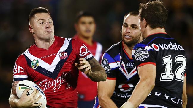 Shaun Kenny-Dowall makes a run at Ryan Hoffman of the Warriors during the round 15 NRL match between the New Zealand Warriors and the Sydney Roosters at Mt Smart Stadium in Auckland. Picture: Anthony Au-Yeung, Getty Images.