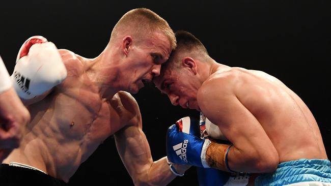 Boxer Liam Wilson (left) lays a blow to Mauro Perouene in an undercard fight ahead of the 'The Reckoning - Horn vs Zerafa 2' middle weight clash between Jeff Horn and Michael Zerafa at the Brisbane Convention and Exhibition Centre in Brisbane, Wednesday, December 18, 2019. (AAP Image/Dan Peled)