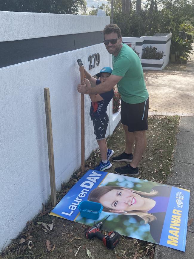 Matthew and Joseph Day putting up signs last week. Photo: supplied.