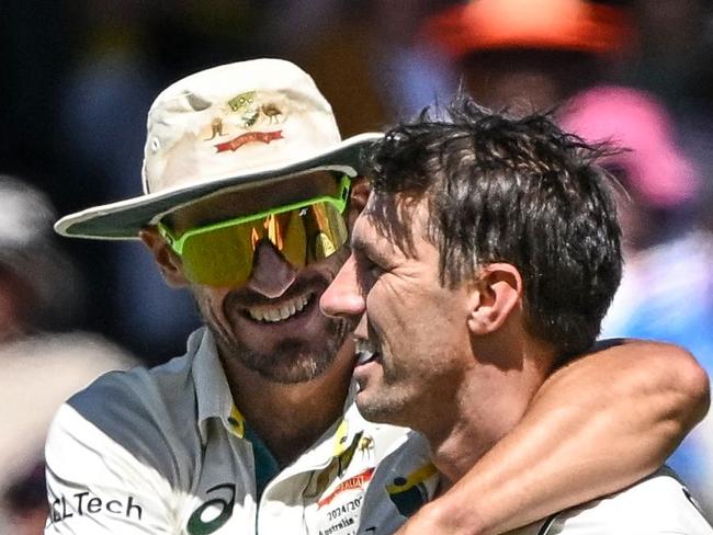 Australia's captain Pat Cummins (R) celebrates his dismissal of  India's Nitish Kumar Reddy with teammate Mitchell Starc (L) on the third day of the second Test cricket match between Australia and India at the Adelaide Oval in Adelaide on December 8, 2024. (Photo by Michael ERREY / AFP) / -- IMAGE RESTRICTED TO EDITORIAL USE - STRICTLY NO COMMERCIAL USE --