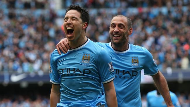 Samir Nasri and Pablo Zabaleta of Manchester City start the celebrations.