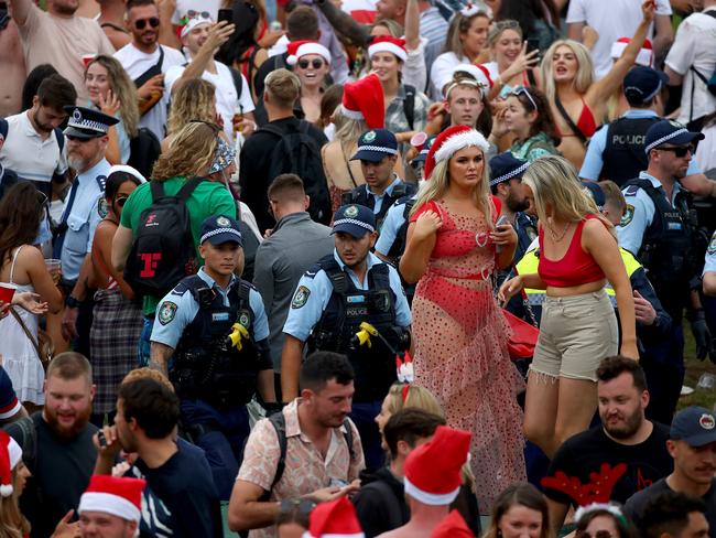 A crowd of mostly backpackers hold an impromptu party at Bronte Beach on Christmas Day with police in attendance to move the large crowd on who were breaching the Covid-19 social distancing rules. Picture: Toby Zerna