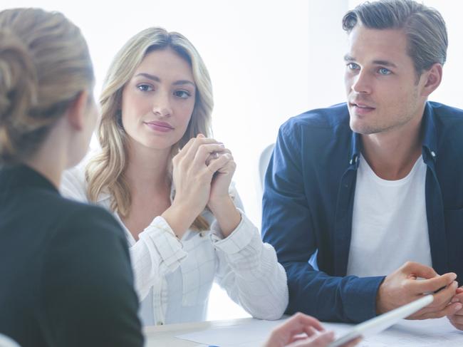 A couple discussing their home loan with a mortgage broker. Picture: iStock.